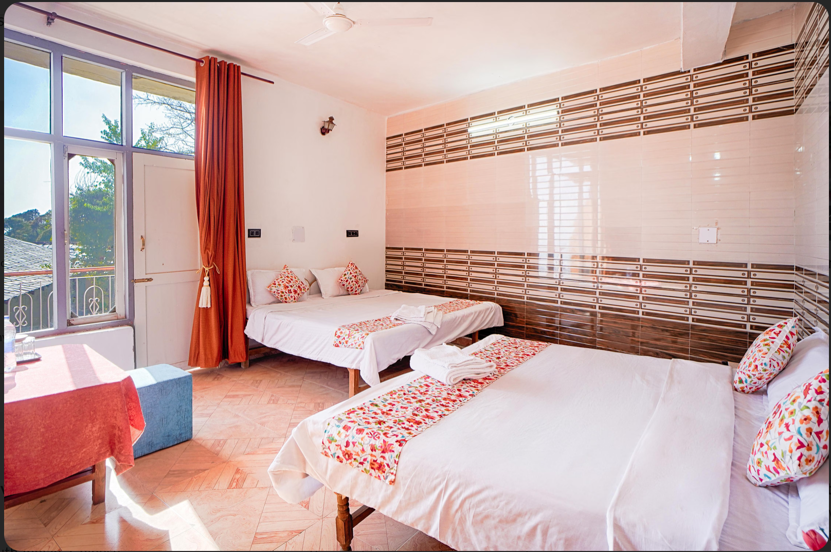 Spacious family room with multiple beds and a balcony